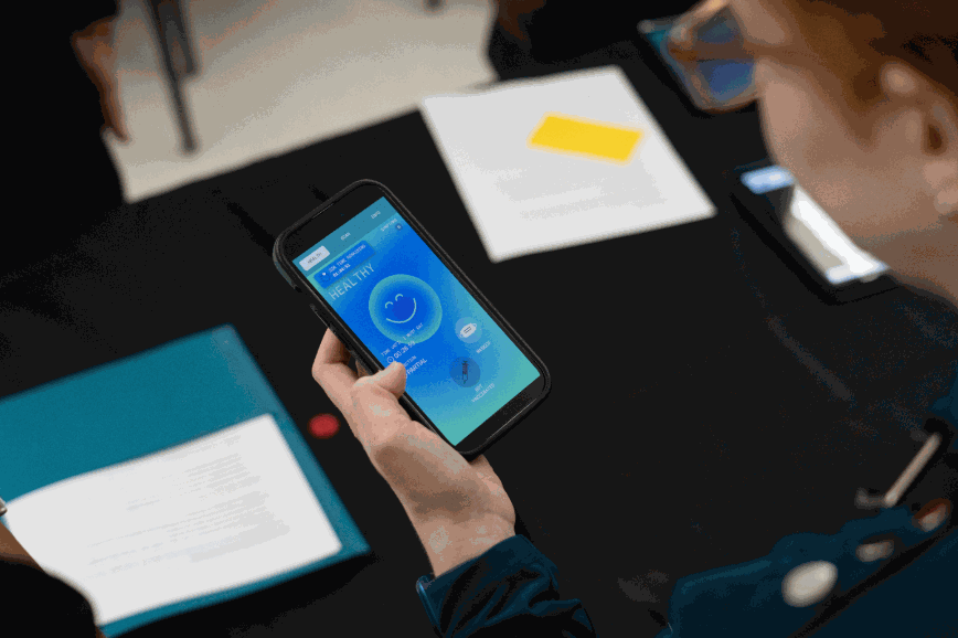 A facilitator checking the participant app before a run