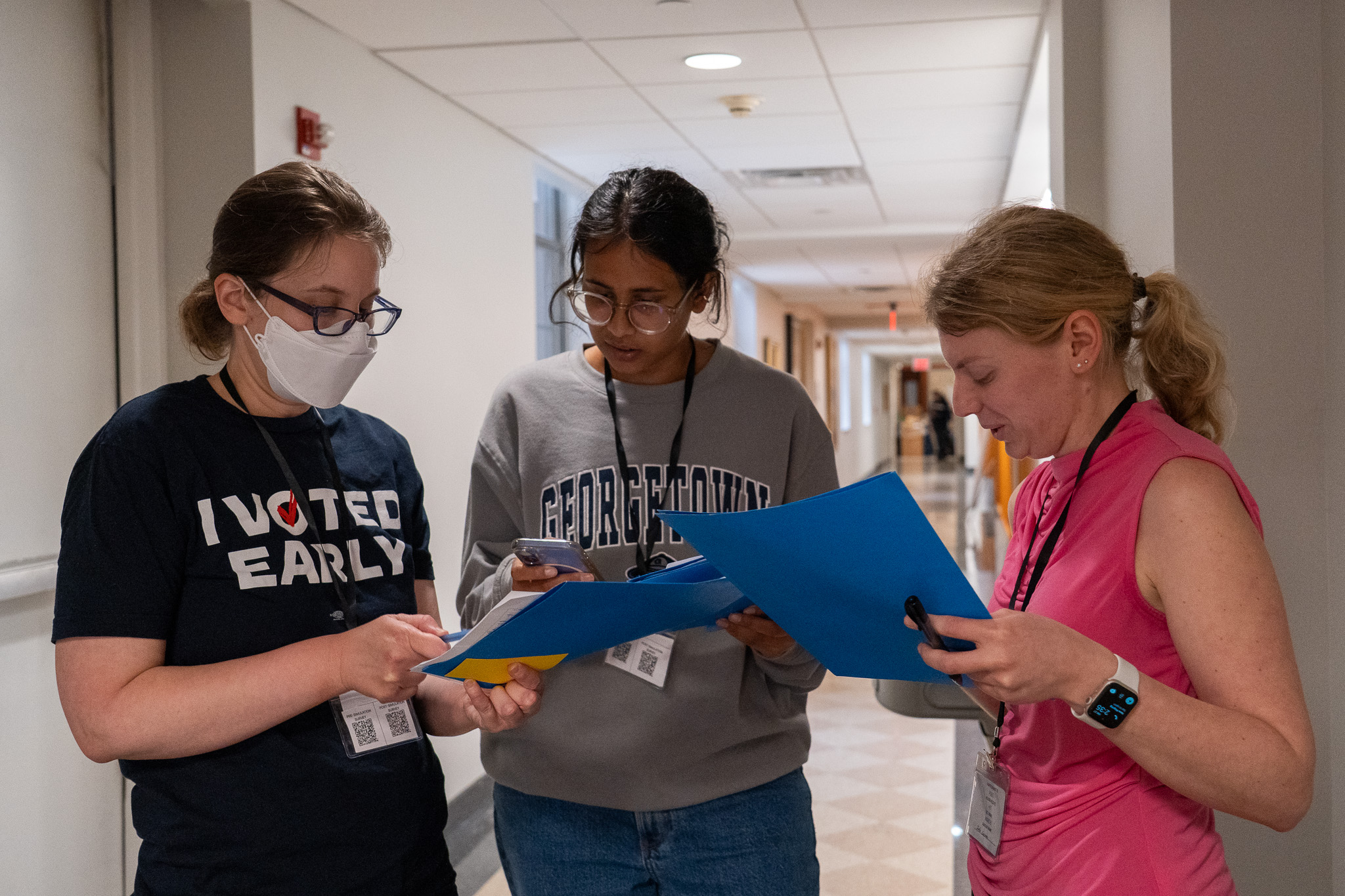 Participants gathered around QR countermeasure sheets, phones in hand