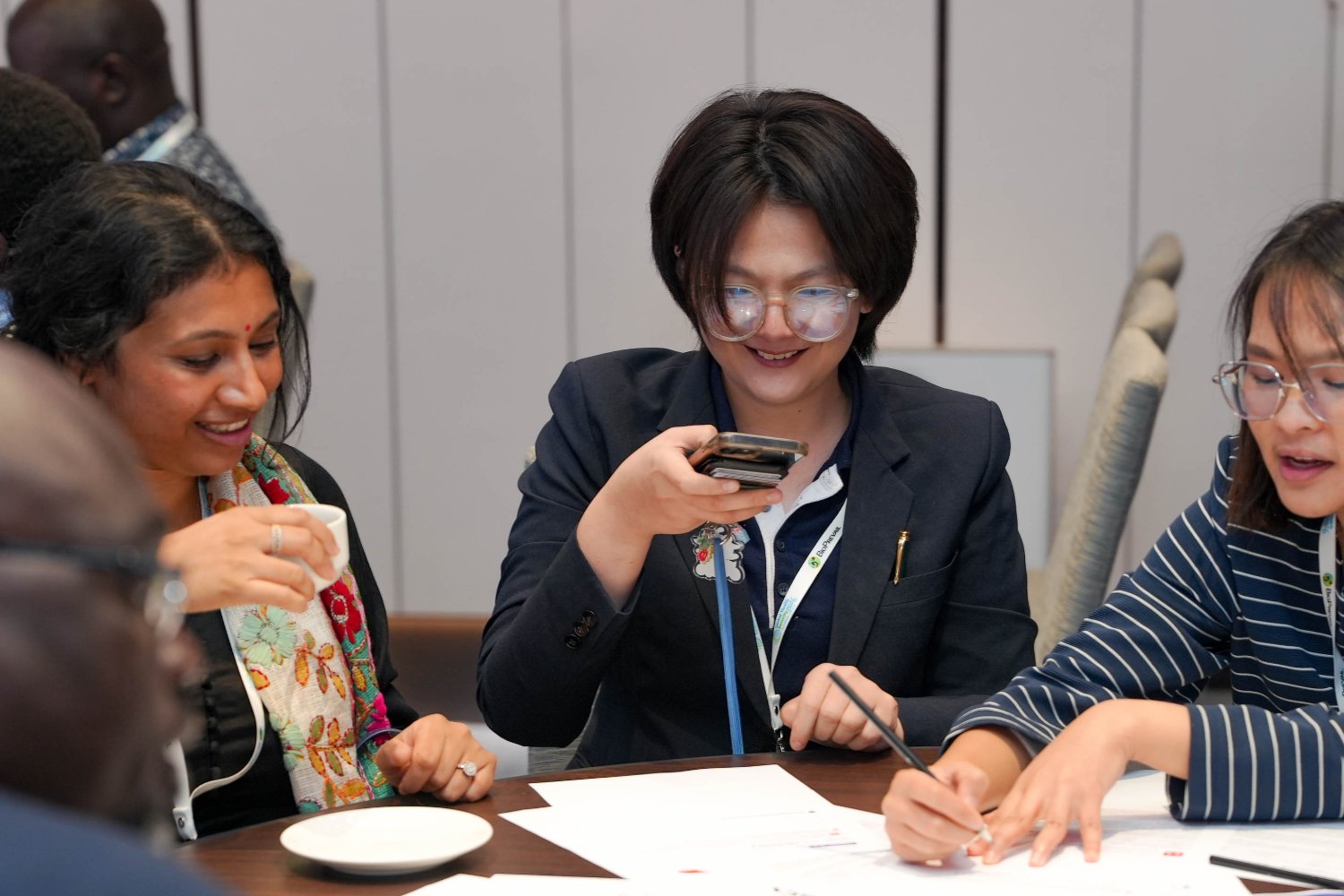 Delegates running the simulation on their phones during a conference session