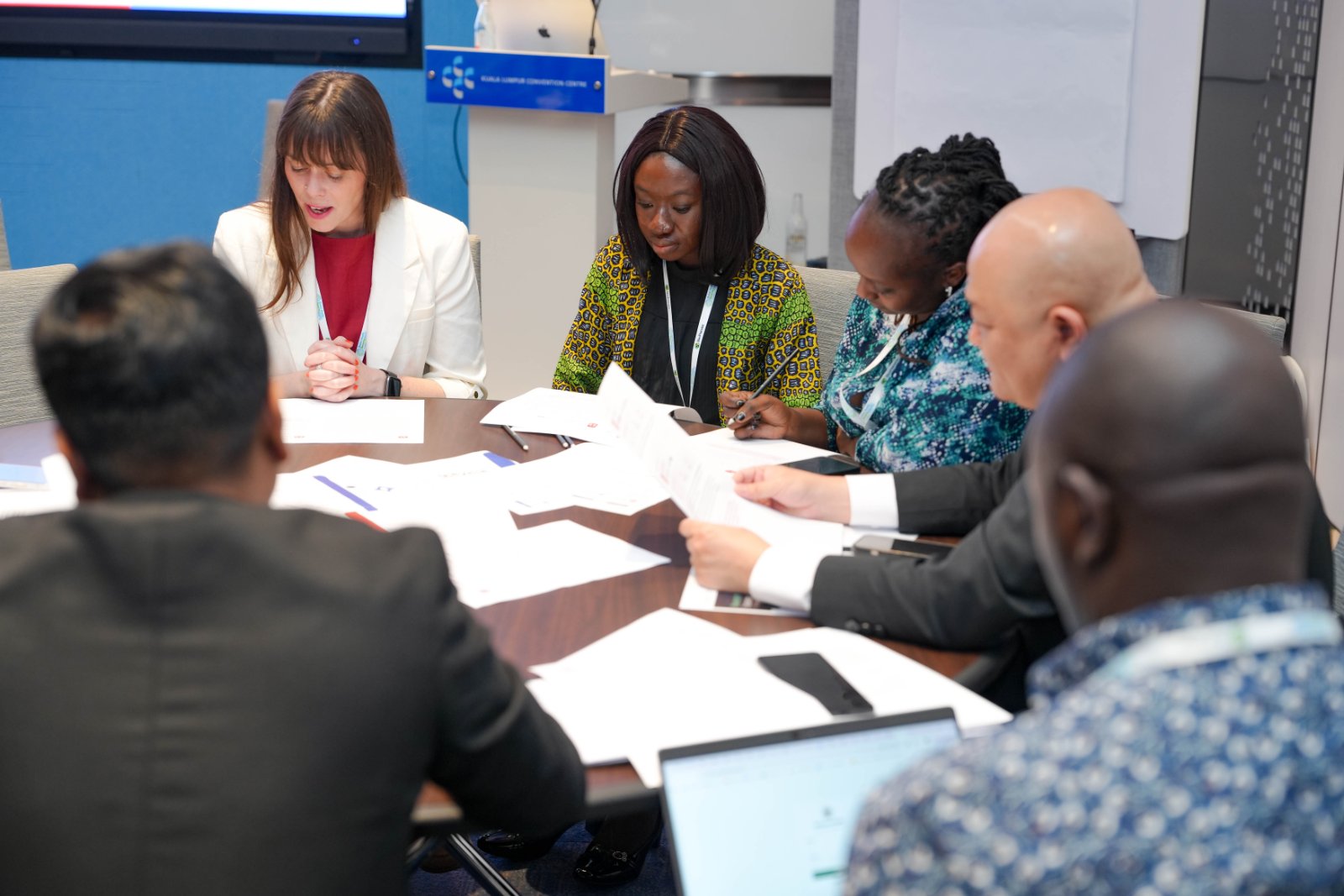 Public health and biosecurity professionals reading through injects during an exercise